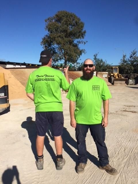 Two Men Wearing Green Shirts With The Word Thomas On The Back — Twin Towns Sand & Gravel In Byron Bay, NSW