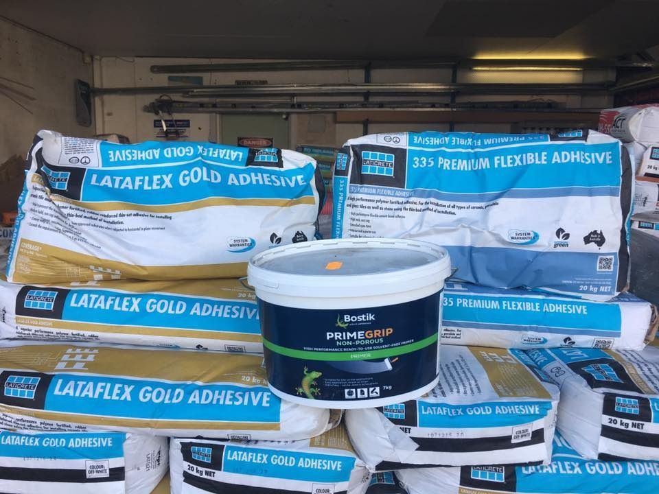 A Bucket Of Lataflex Gold Adhesive Sits On Top Of A Pile Of Bags — Twin Towns Sand & Gravel In Tweed Heads South, NSW