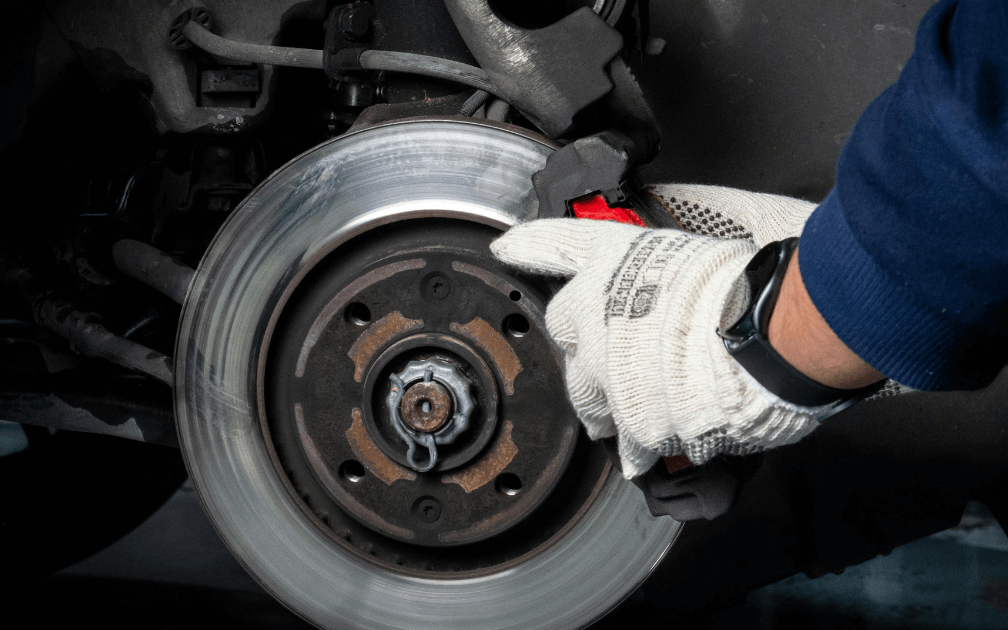 a mechanic doing at-home brake repair service
