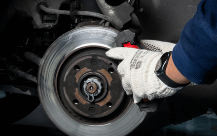 a mechanic doing at-home brake repair service