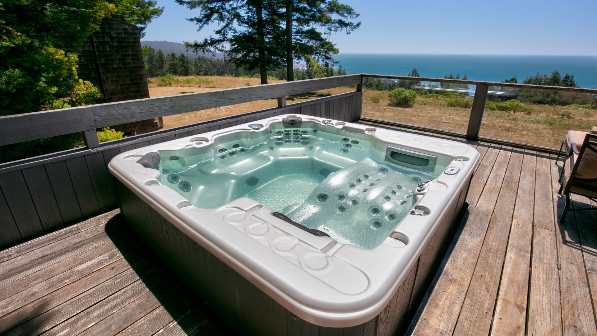 Hot tub on an aged wooden deck overlooking a tranquil sea view, surrounded by nature in Chula Vista.