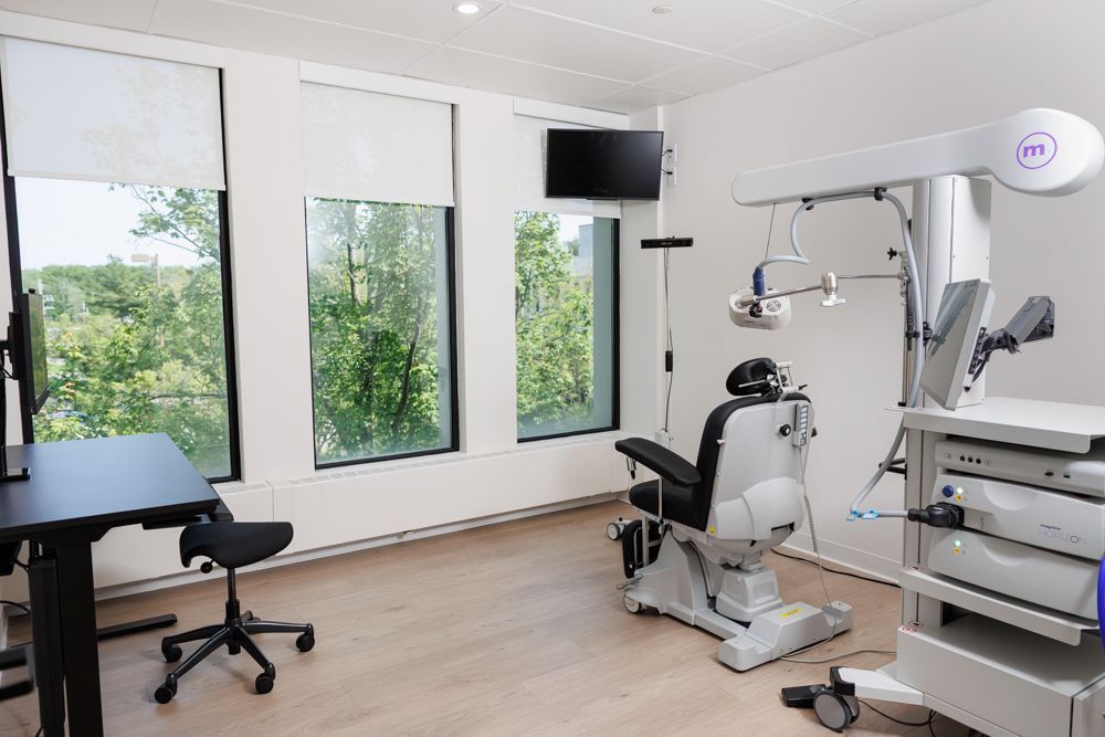 A dental office with a dental chair and a desk.