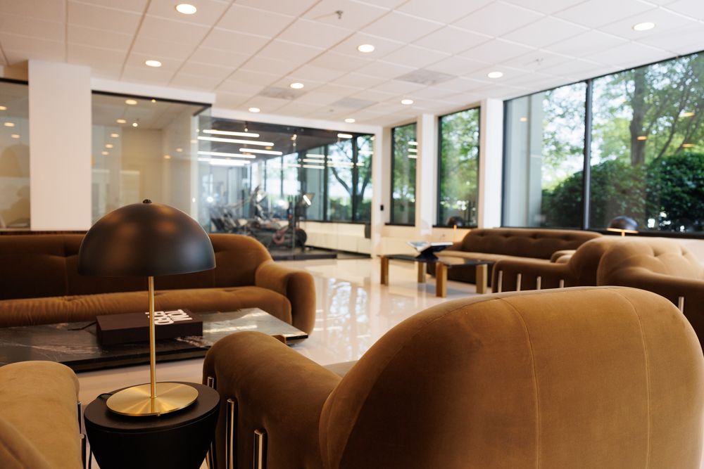 A living room filled with furniture and a lamp.
