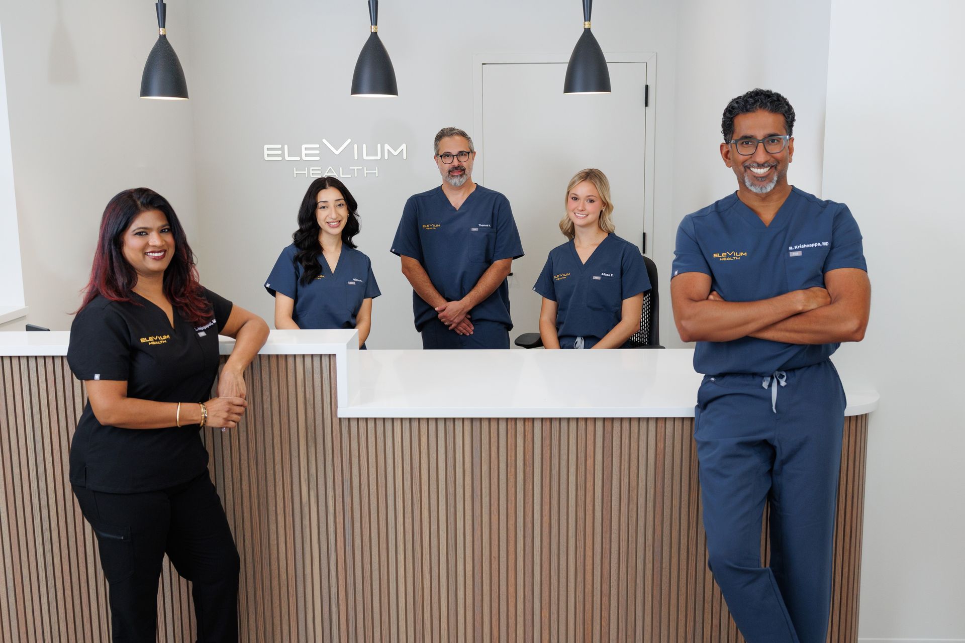 A man and a woman are sitting in chairs talking to each other.