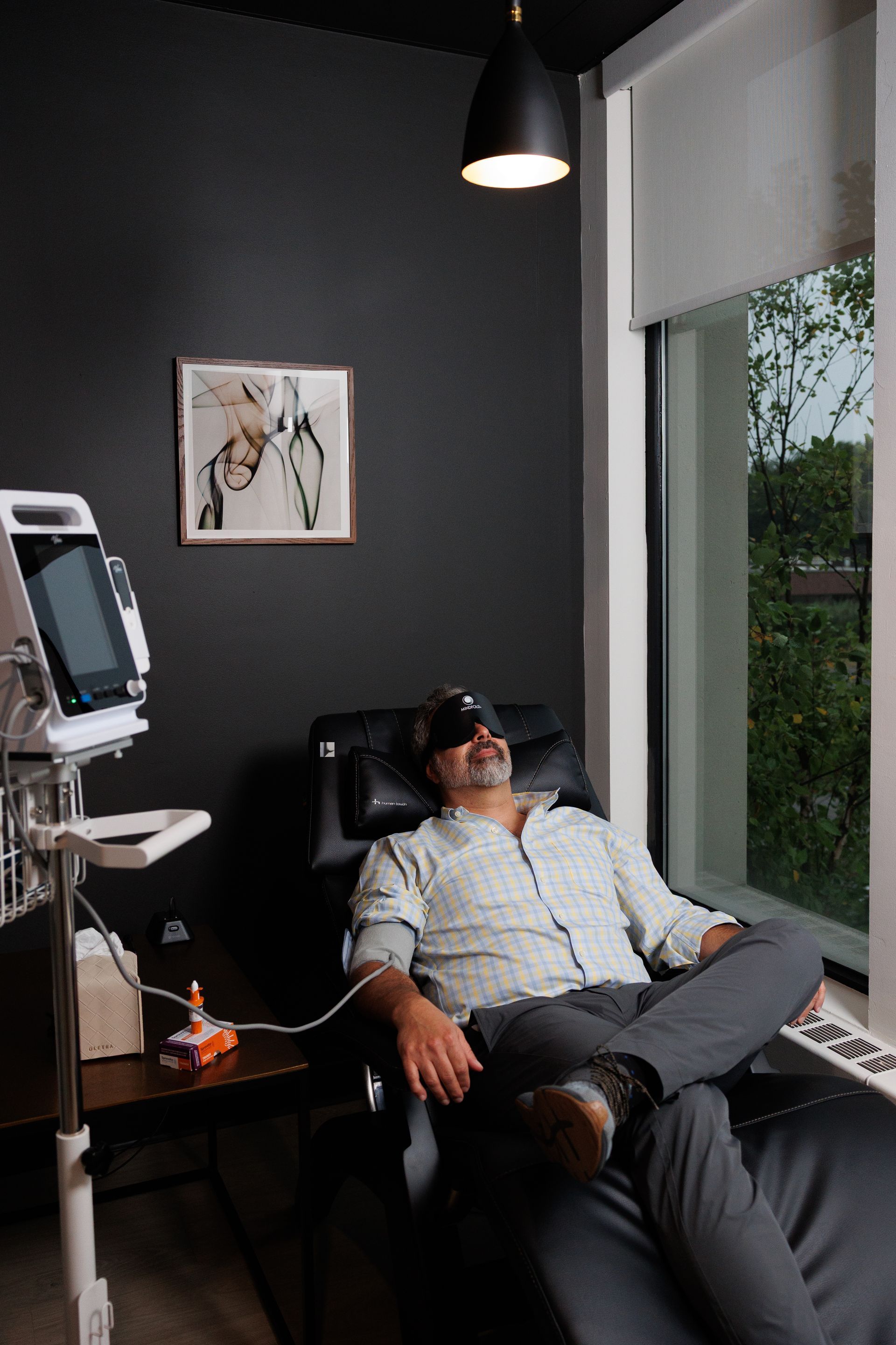 A vase of flowers is sitting on a table in a living room.