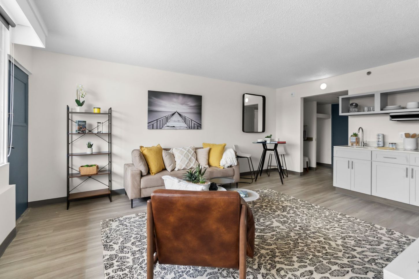A living room with a couch , chair , and rug.