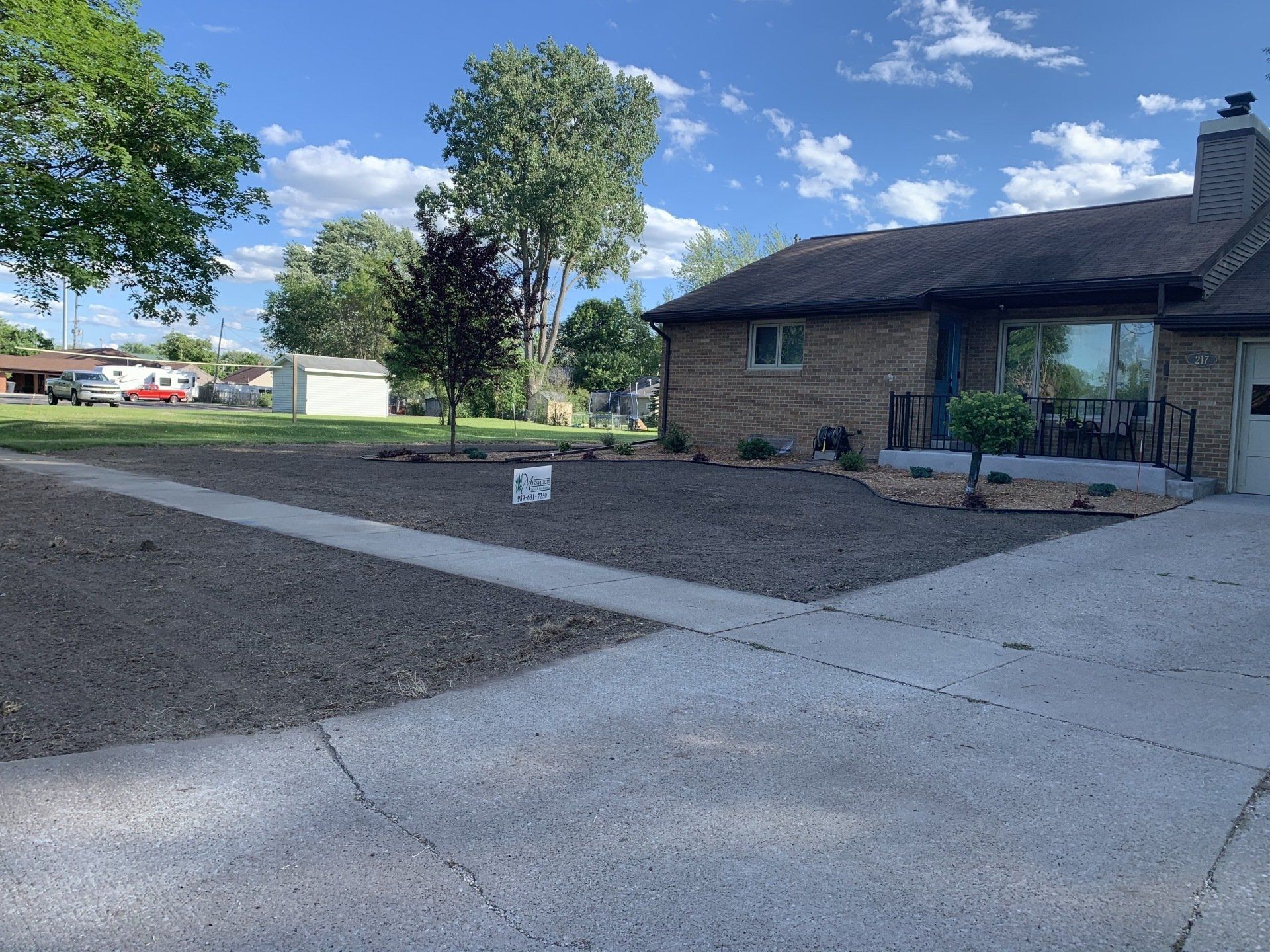 Client with Dry Land and Concrete Pathway — Midland, MI — Maksymum Lawn and Landscaping