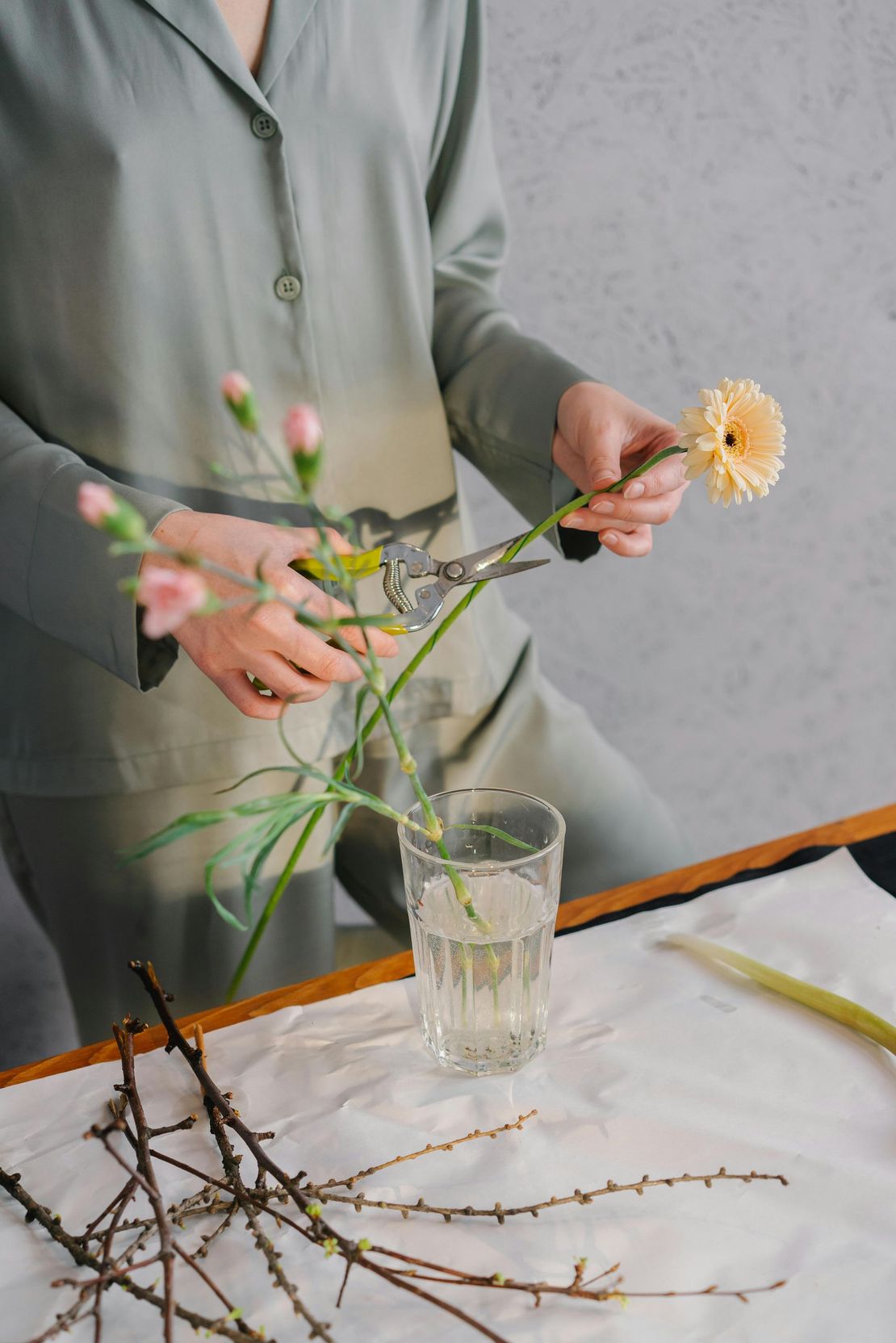 A woman cutting and arranging flowers near Geist, Indiana