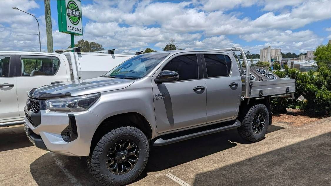 A Silver Truck With a Flat Bed is Parked in a Parking Lot — High Grade Tyre and Mechanical in Toowoomba City, QLD