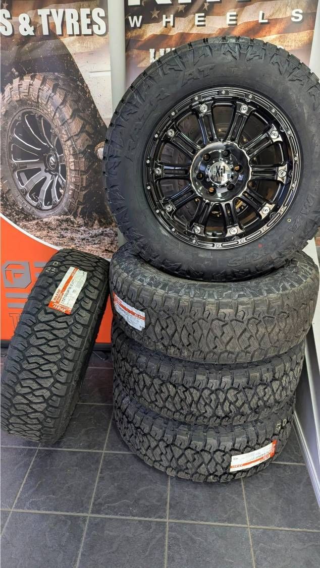 A Stack of Tires and Wheels Are Sitting on a Tiled Floor — High Grade Tyre and Mechanical in Toowoomba City, QLD