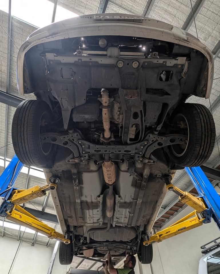 A Black Car Lifted Up — High Grade Tyre and Mechanical in Toowoomba City, QLD