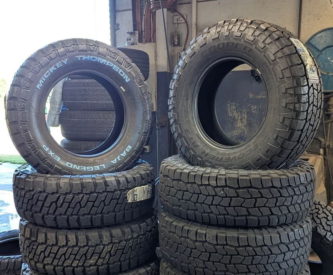 A Bunch of Wheels Are Stacked on Top of Each Other on a Rack — High Grade Tyre and Mechanical in Toowoomba City, QLD