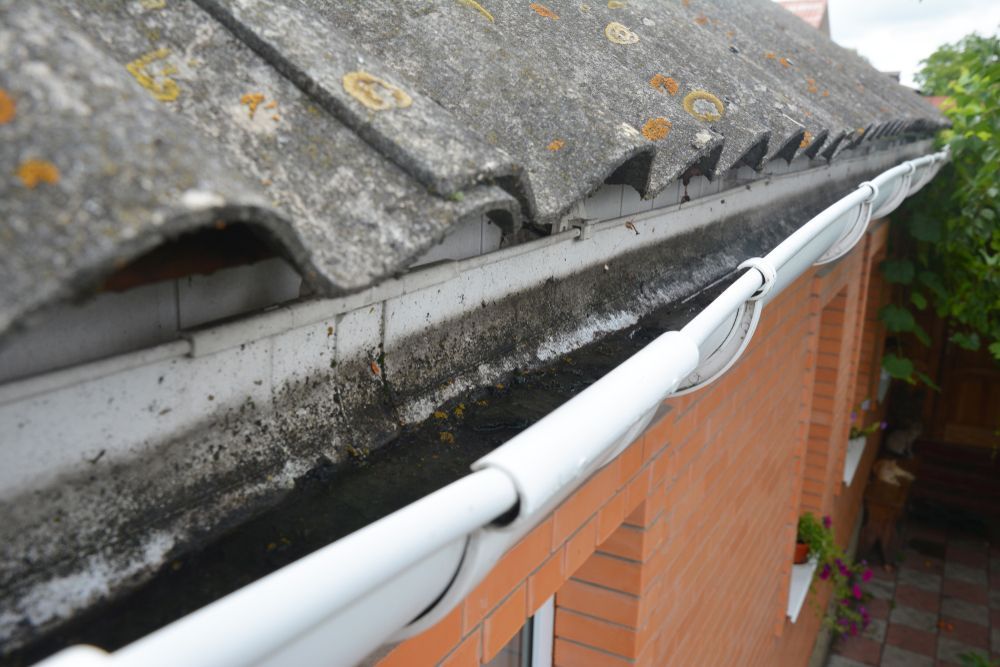 A Gutter Is Hanging From The Roof Of A House — Richardson Plumbing & Gas Service In Port Macquarie, NSW