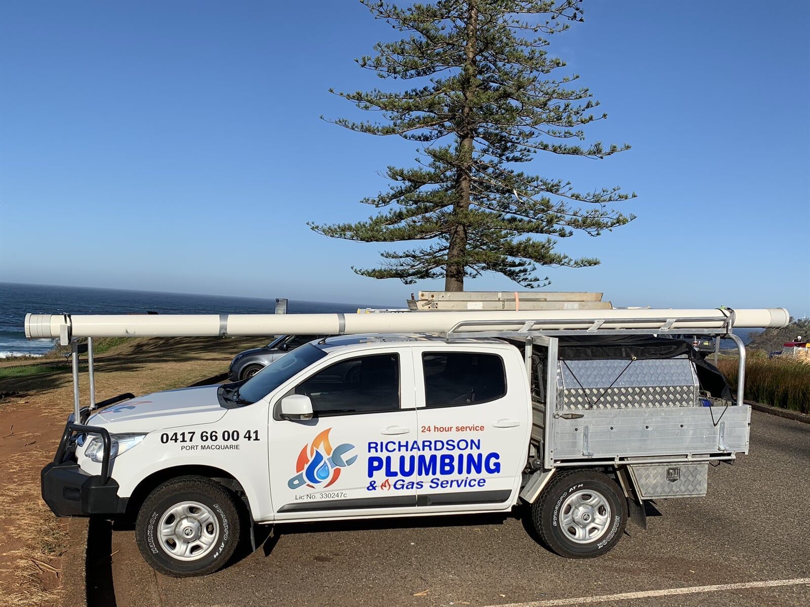 A Plumbing Truck Is Parked Next To A Tree — Richardson Plumbing & Gas Service In Port Macquarie, NSW