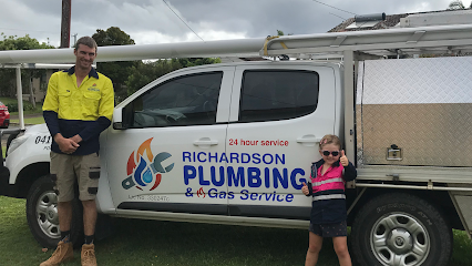 A Plumber man and a young kid standing in the front of a labelled ute - Richardson plumbing & Gas Service 