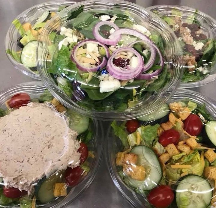 Five salads in plastic containers