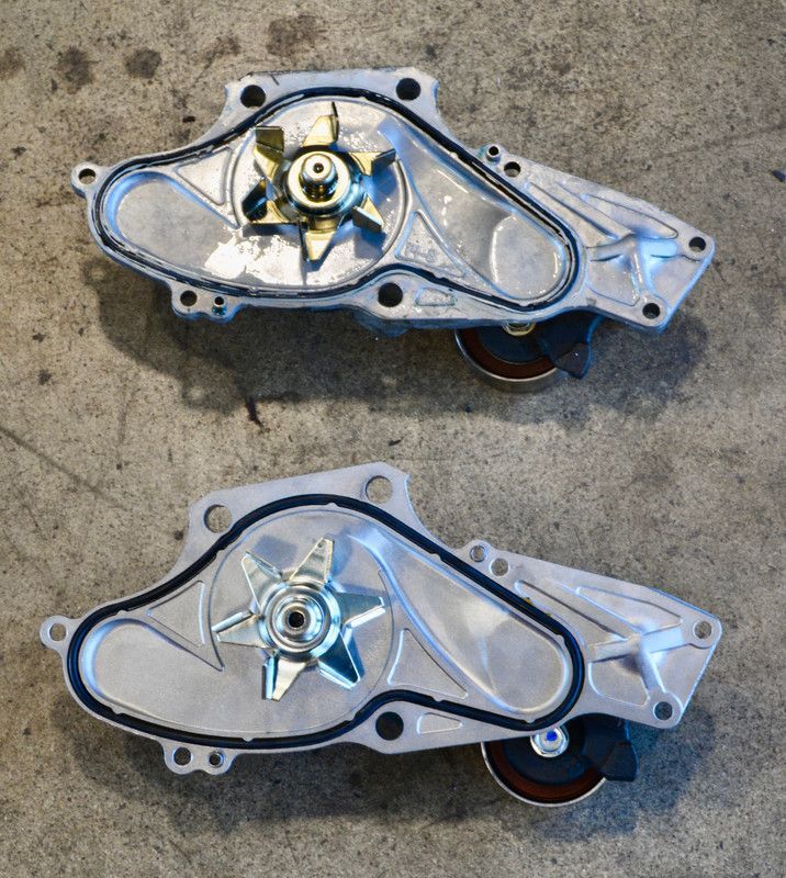 Two water pumps are sitting on a concrete surface | Paul Campanella's Auto Centers
