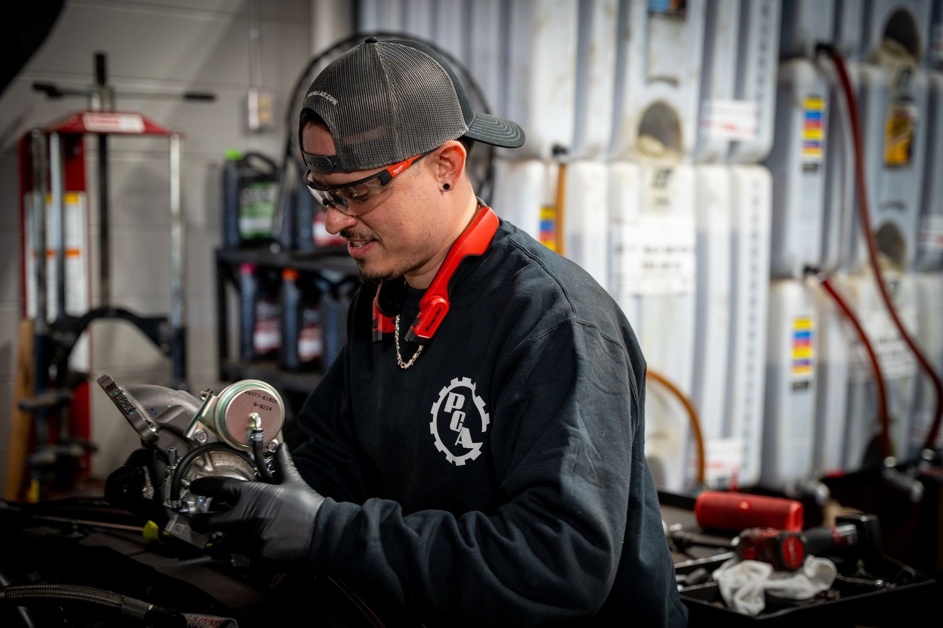 Technician installing cooling system t under the hood