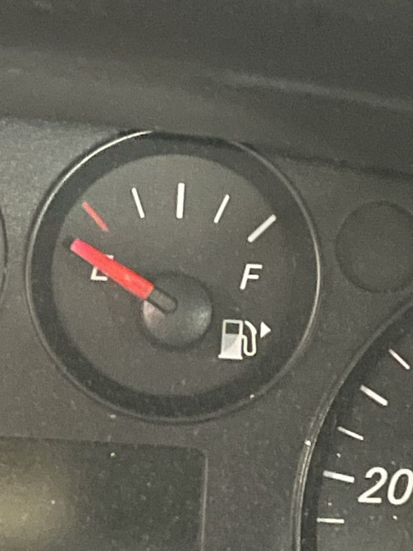 A close up of a fuel gauge on a car