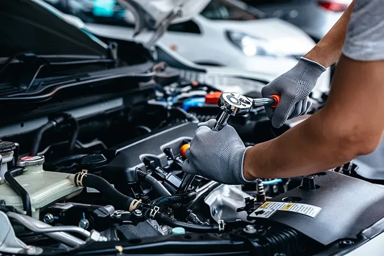 Mechanic working on engine | Paul Campanella's Auto Centers