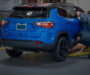 Blue SUV on lift | Paul Campanella's Auto Centers