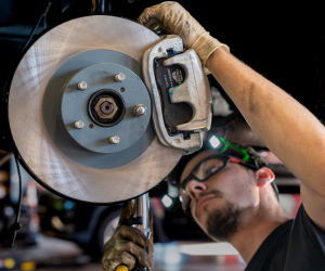 Mechanic working on car brakes | Paul Campanella's Auto Centers