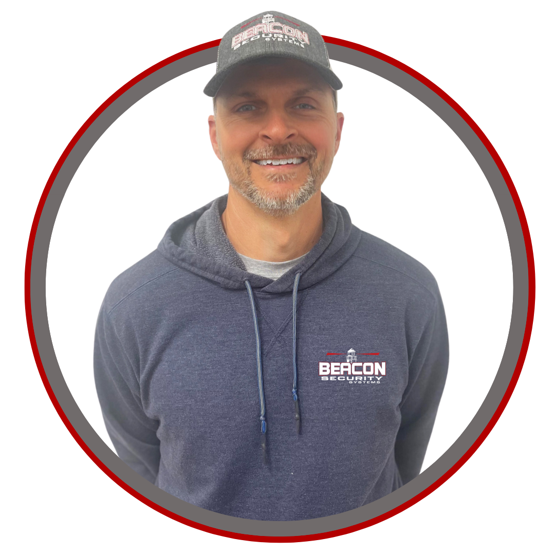 a man wearing a hat and a hoodie with the word beacon on it