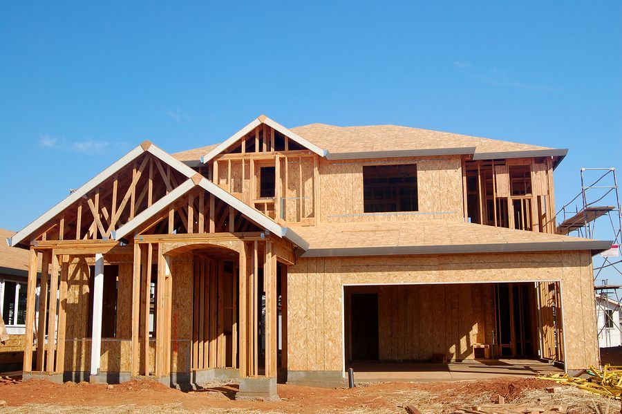 A house is being built with a blue sky in the background.