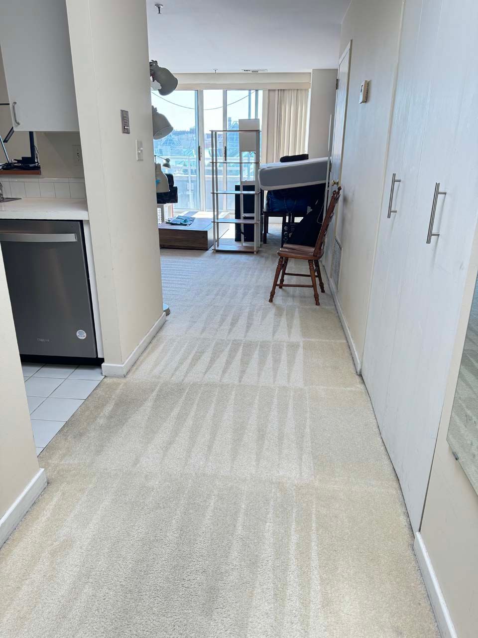 A hallway in a house with a chair in the middle