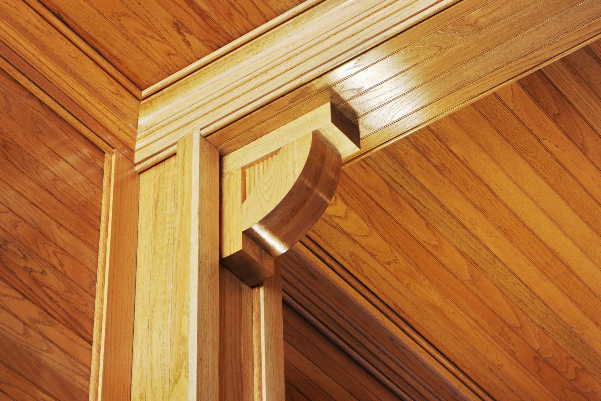 A close up of a wooden ceiling with a corbel on it.