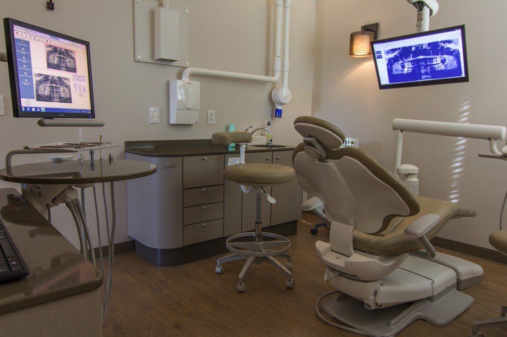 dental procedure room with x-rays on screen