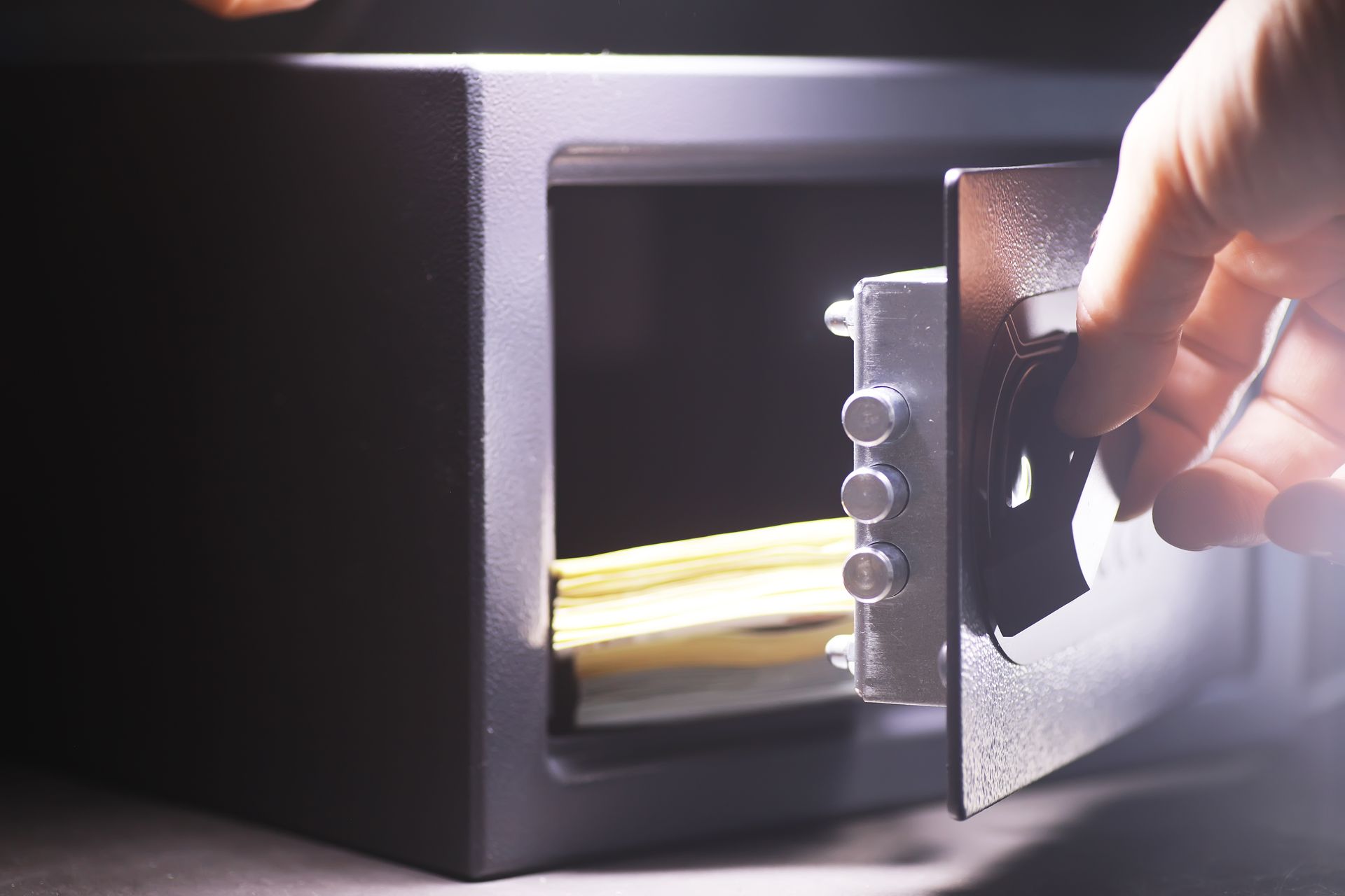 A person is opening a safe with a key in it.