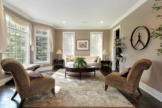 A living room with two chairs and a couch