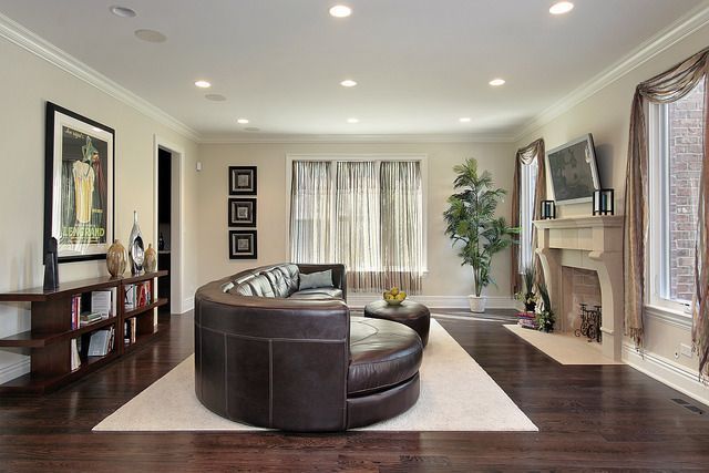 A living room with a couch , fireplace and television.