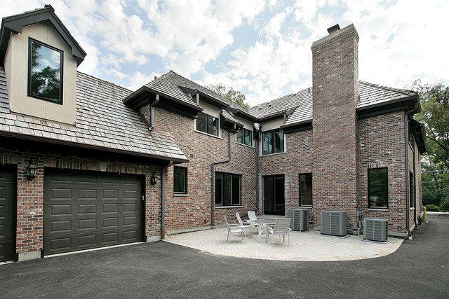 A large brick house with a garage and a patio
