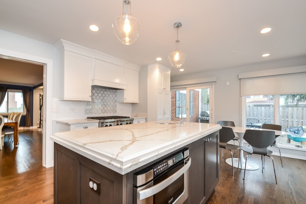 A kitchen with a large island and stainless steel appliances.