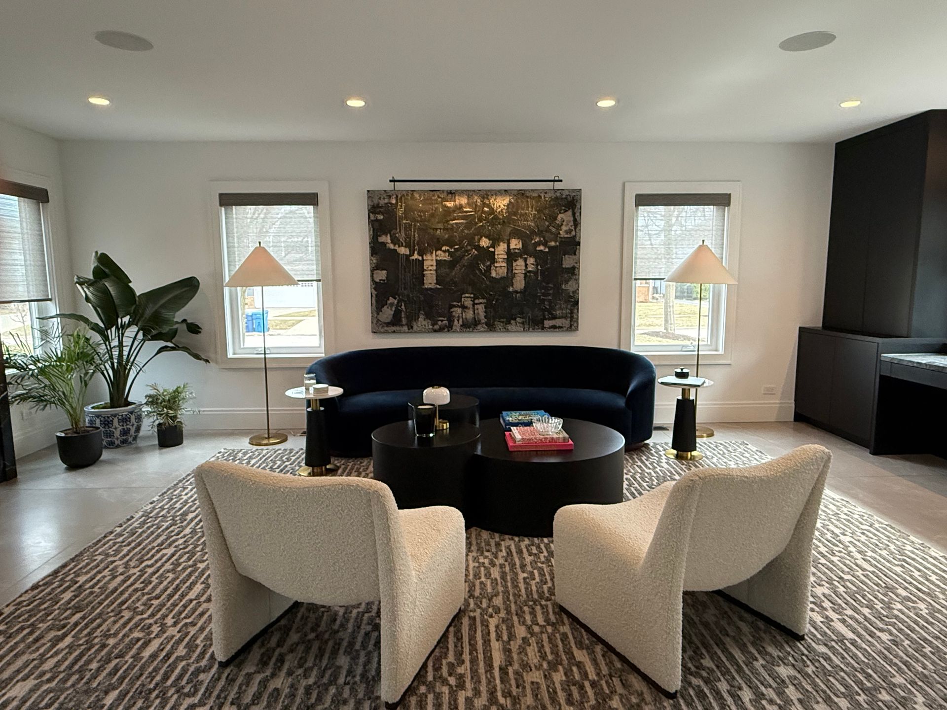 A living room with a couch and two chairs