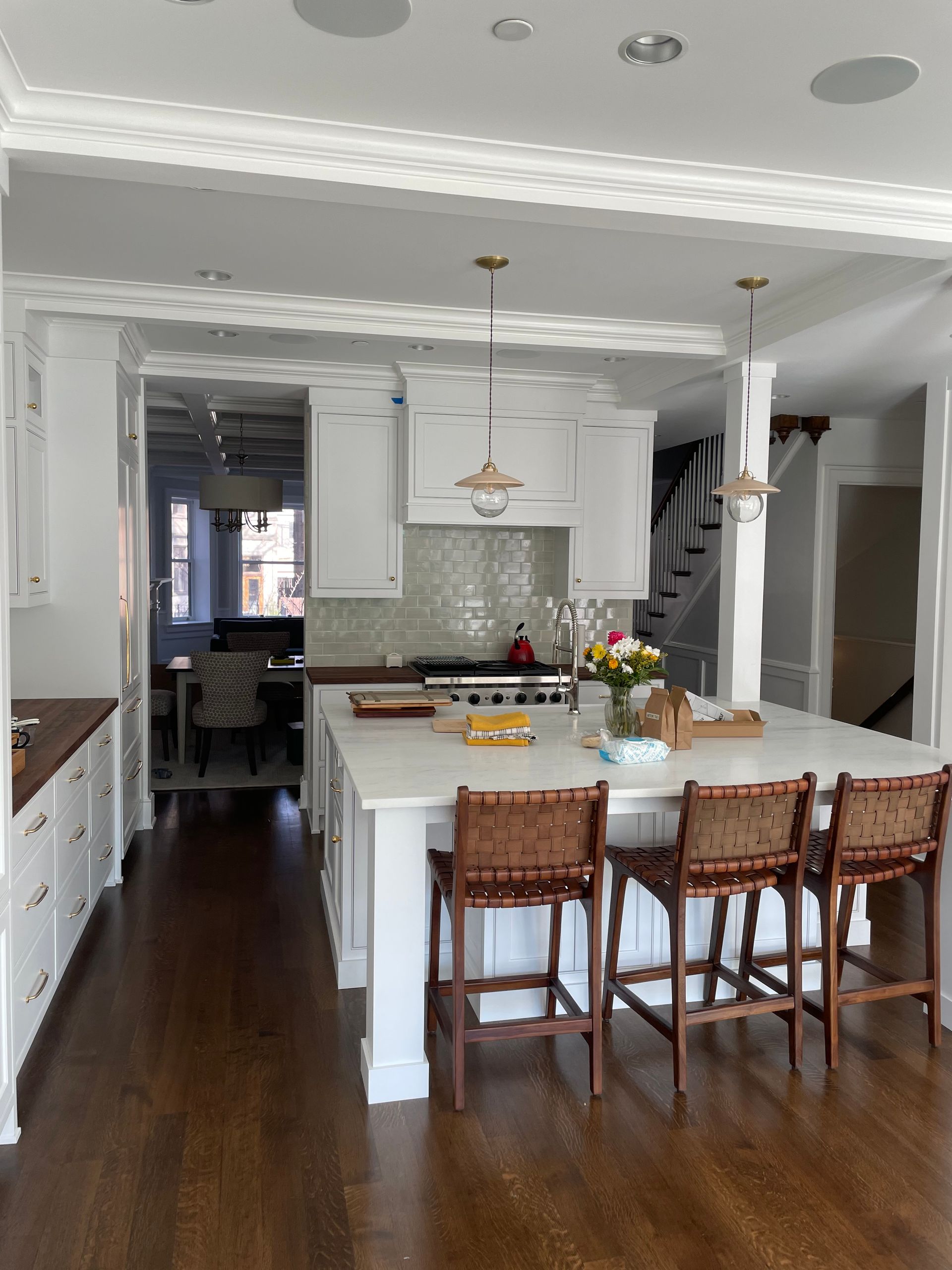 A kitchen with white cabinets and a large island