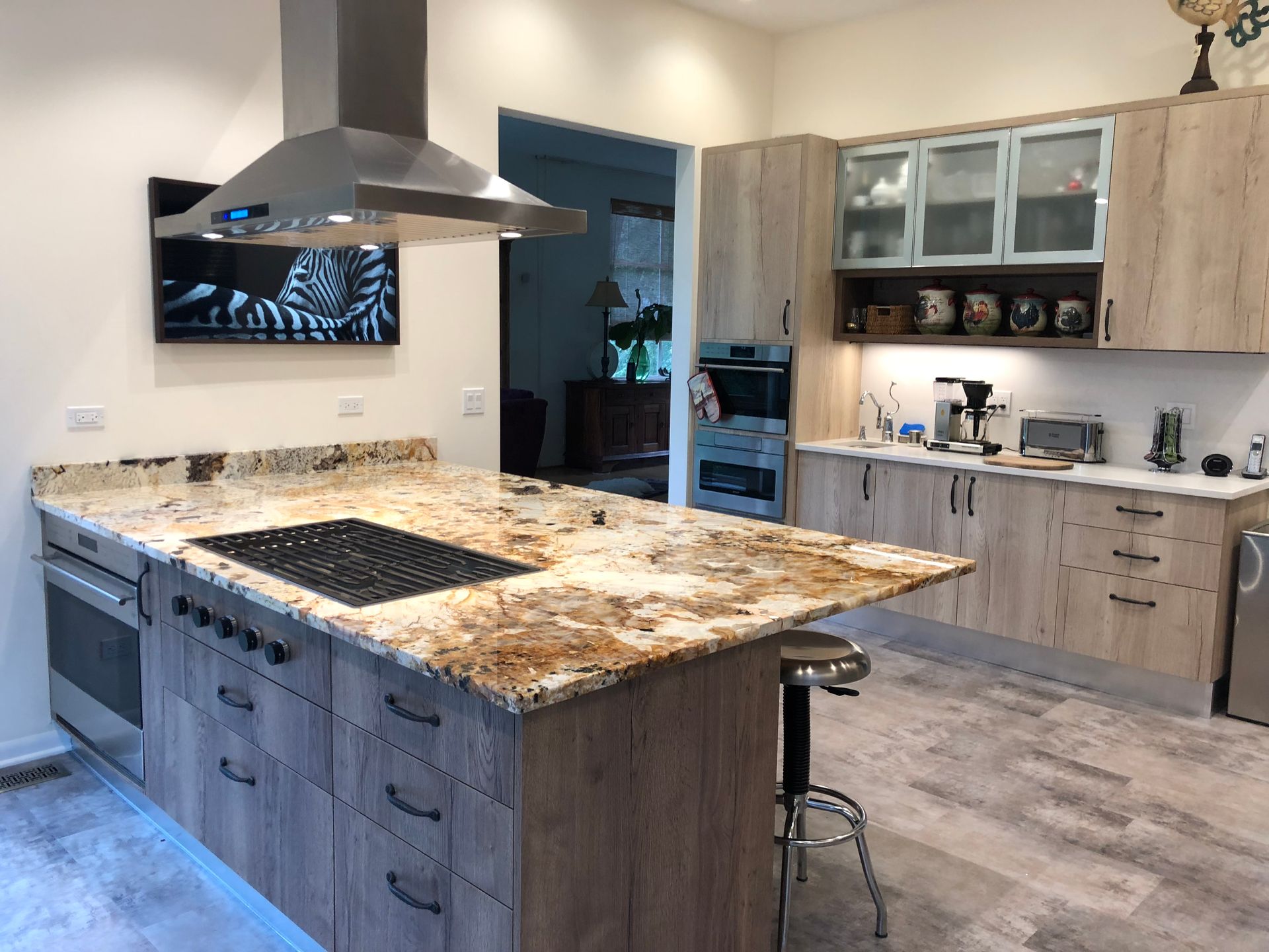 A kitchen with a large island and a stove top oven