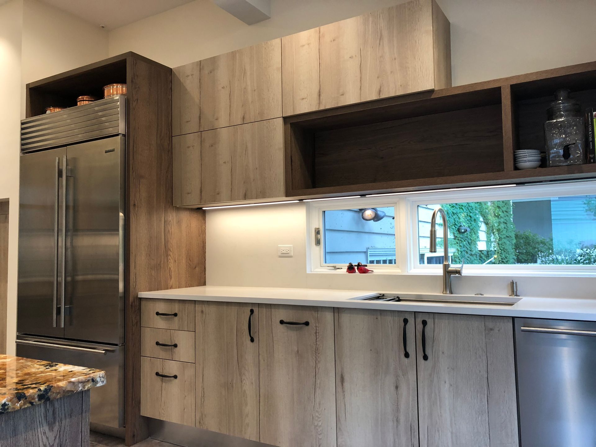 A kitchen with wooden cabinets and stainless steel appliances