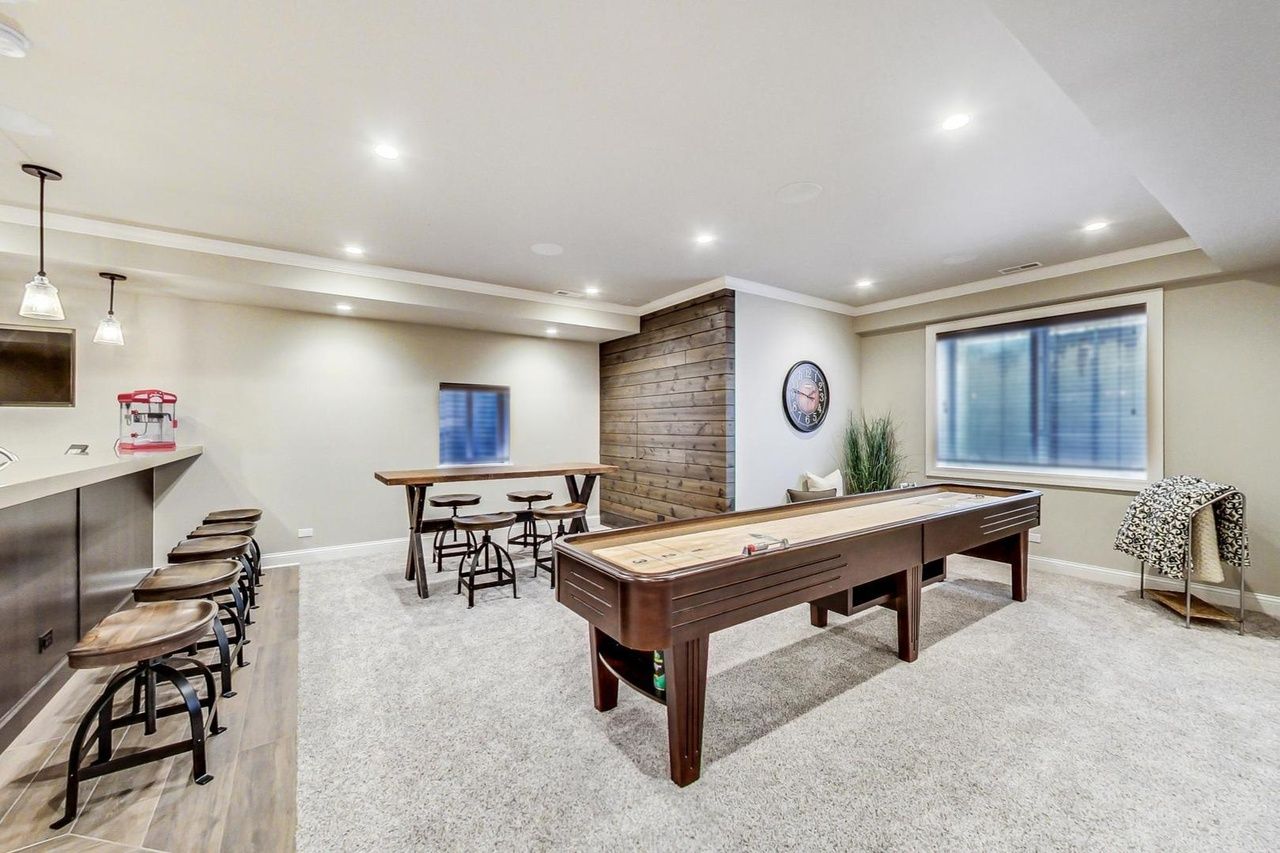 There is a pool table in the middle of the room.