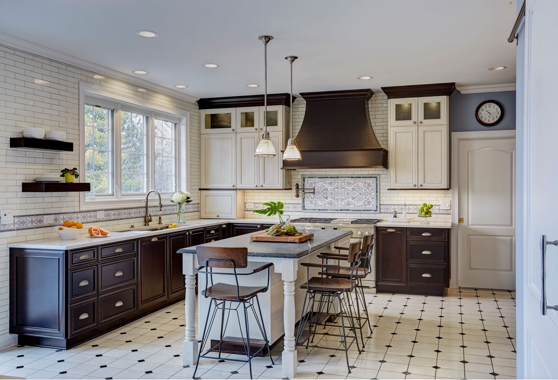 A kitchen with black and white cabinets and a large island.
