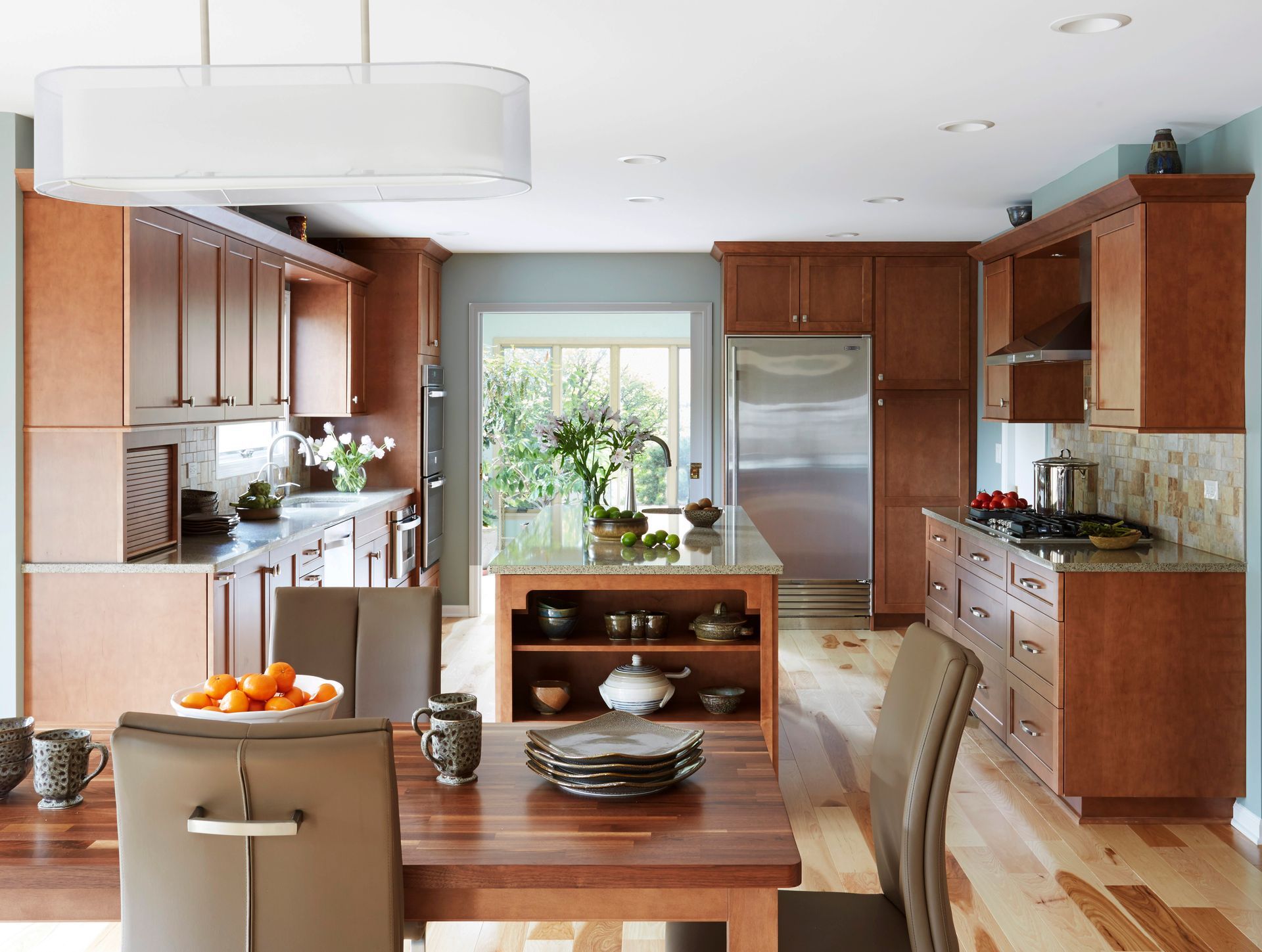 A kitchen with wooden cabinets and stainless steel appliances