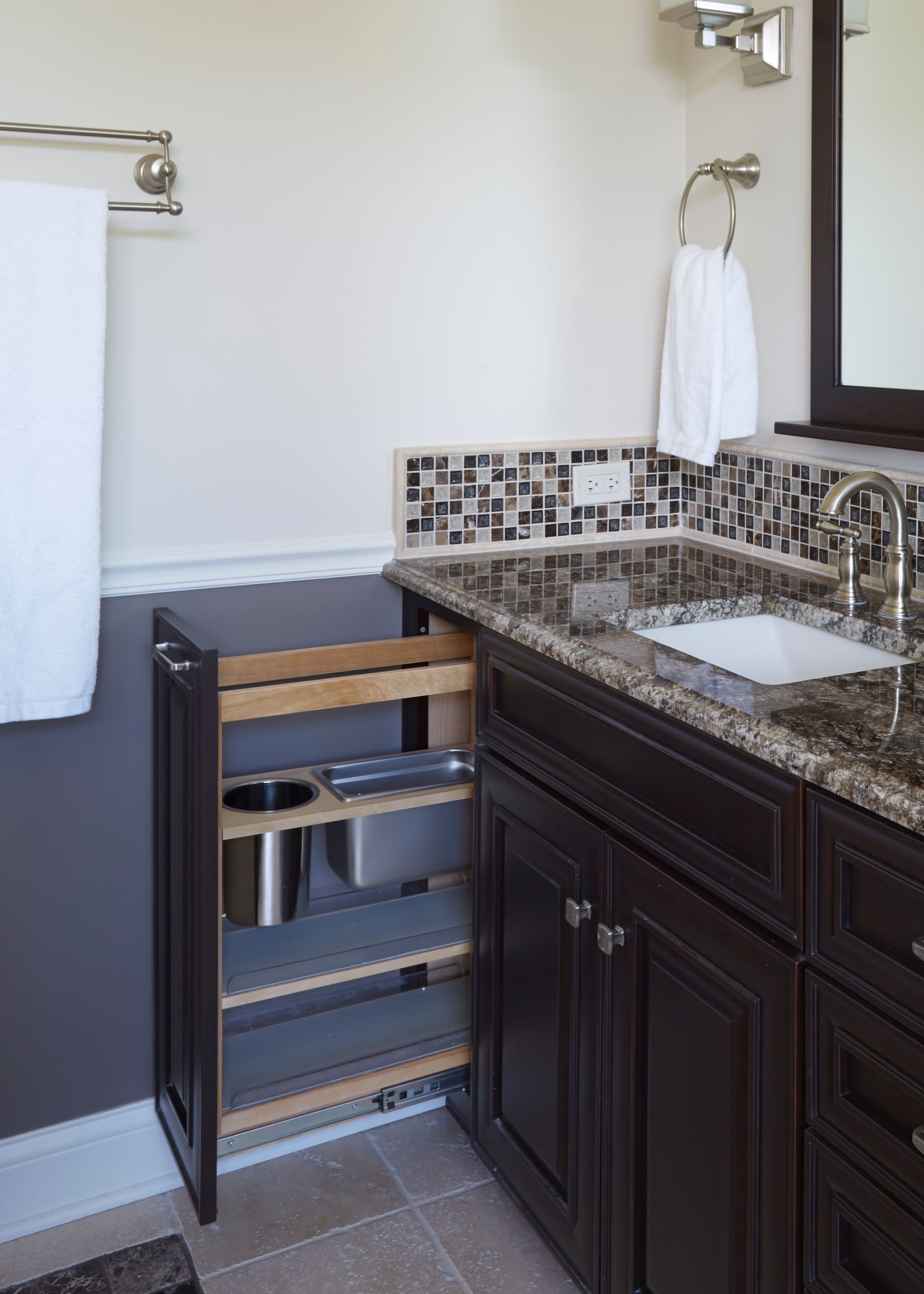 A bathroom with a sink and a pull out shelf