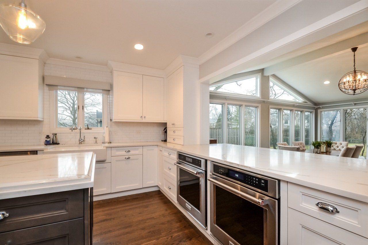 A kitchen with white cabinets and stainless steel appliances.