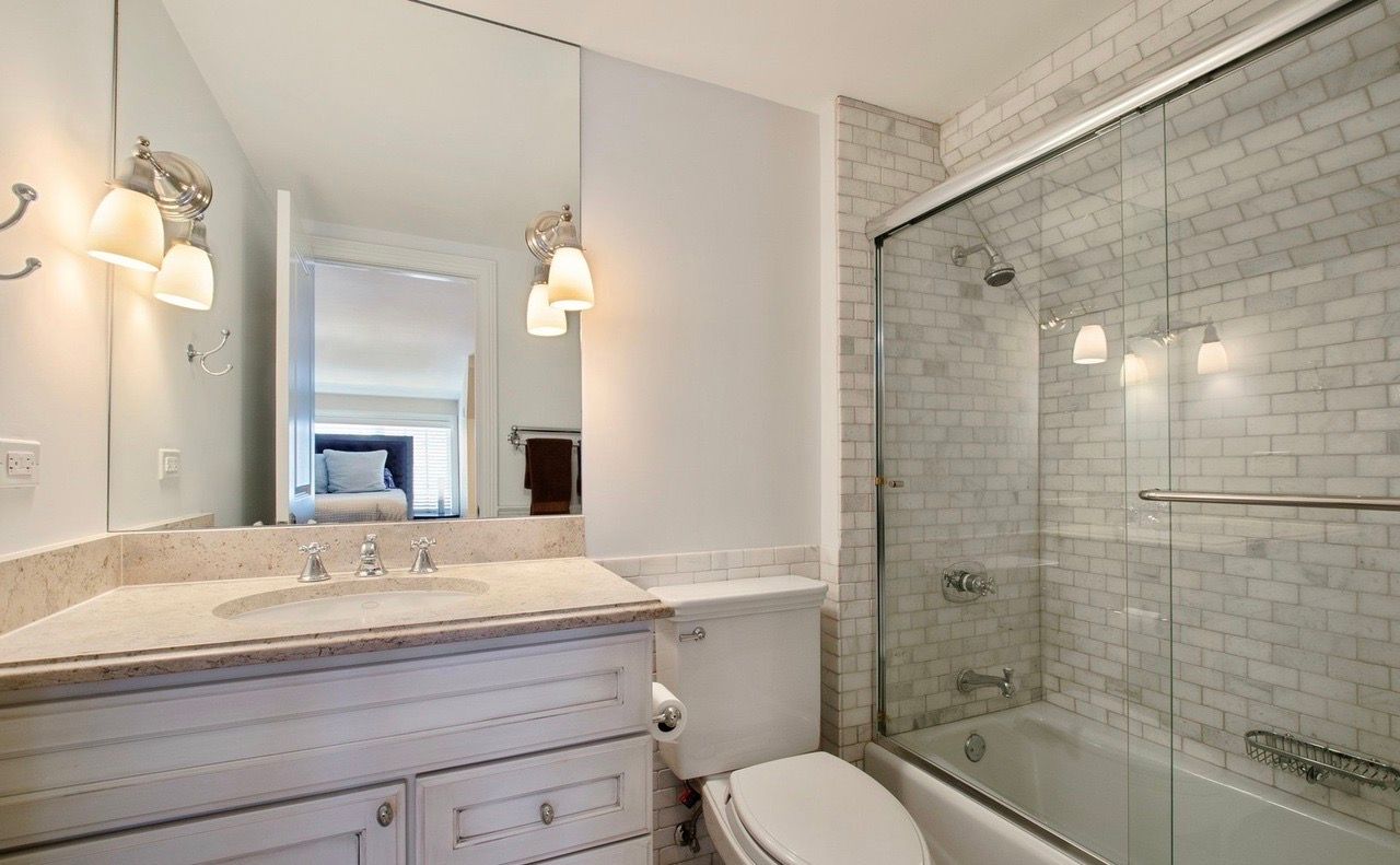 A bathroom with a sink , toilet , tub and shower.