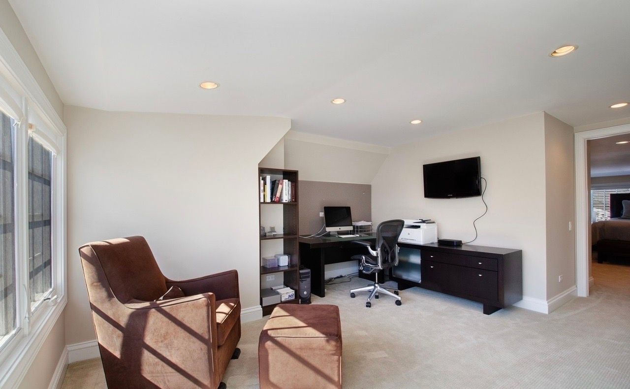 A living room with two chairs and a desk