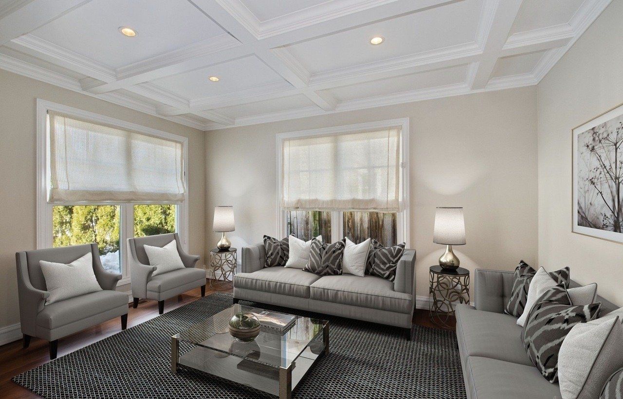 A living room with a couch , chairs , and a coffee table.
