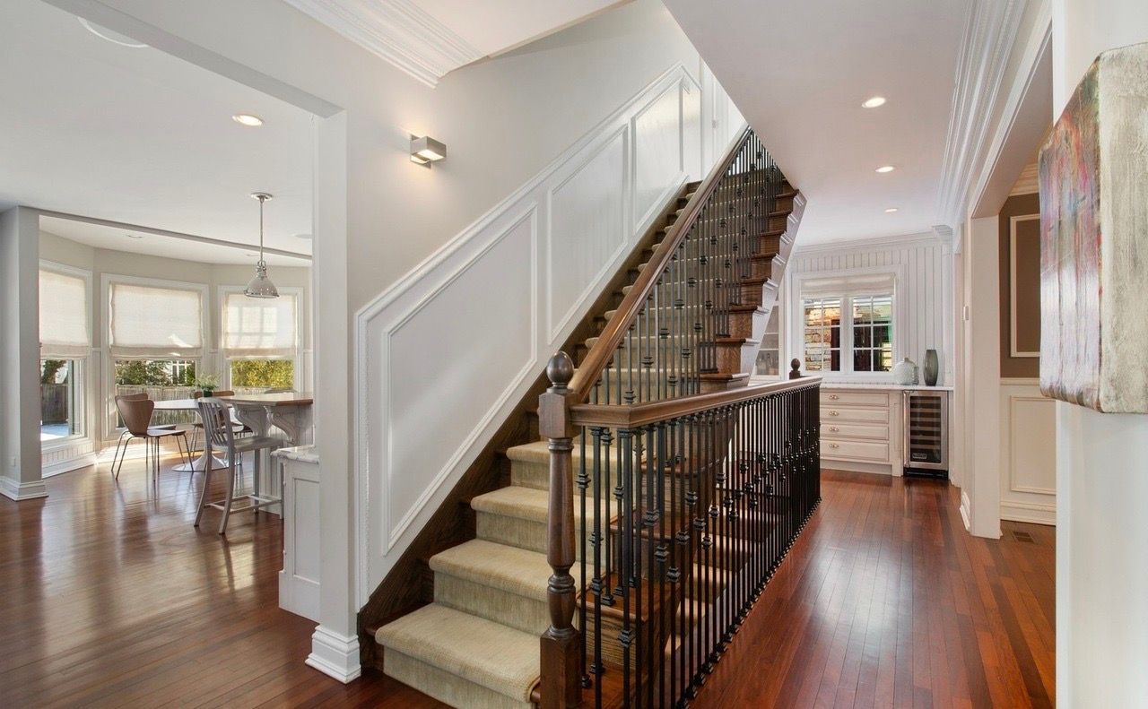 A hallway with stairs leading up to the second floor of a house.