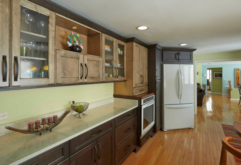 A kitchen with brown cabinets and a white refrigerator